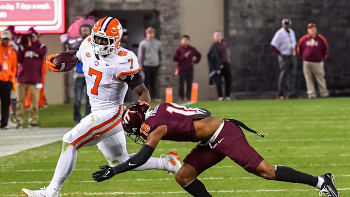 Nov 9, 2024; Blacksburg, Virginia, USA; Virginia Tech Hokies safety Mose Phillips III (18) dives to tackle Clemson Tigers running back Phil Mafah (7) as he runs the ball during the third quarter at Lane Stadium. Mandatory Credit: Brian Bishop-Imagn Images Nov 9, 2024; Blacksburg, Virginia, USA; Virginia Tech Hokies safety Mose Phillips III (18) dives to tackle Clemson Tigers running back Phil Mafah (7) as he runs the ball during the third quarter at Lane Stadium. Mandatory Credit: Brian Bishop-Imagn Images