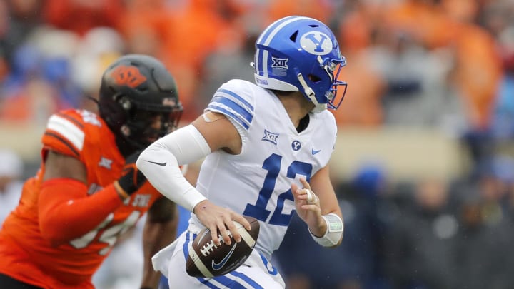 Nov 25, 2023; Stillwater, Oklahoma, USA; BYU's Jake Retzlaff (12) scrambles during the first half Nov 25, 2023; Stillwater, Oklahoma, USA; BYU's Jake Retzlaff (12) scrambles during the first half