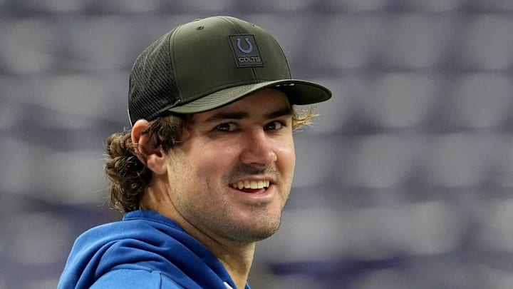 Indianapolis Colts quarterback Daniel Jones talks with team staff