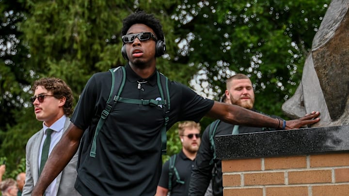 Michigan State's Aidan Chiles touches the foot of the Sparty statue before the game against Florida Atlantic on Friday, Aug. 30, 2024, outside Spartan Stadium in East Lansing.