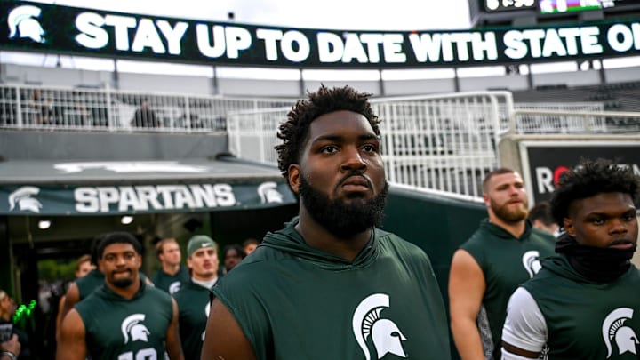 Michigan State's Kristian Phillips and the Spartans take the field for warm ups before the game against Florida Atlantic on Friday, Aug. 30, 2024, at Spartan Stadium in East Lansing.