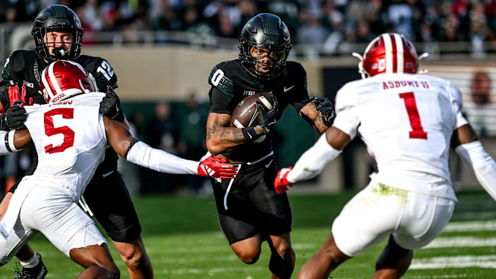 Michigan State's Alante Brown, center, runs the ball against Indiana during the first quarter on Saturday, Nov. 2, 2024, at Spartan Stadium in East Lansing.