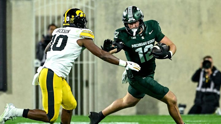 Michigan State's Jack Velling, right, runs after a catch as Iowa's Nick Jackson closes in during the third quarter on Saturday, Oct. 19, 2024, at Spartan Stadium in East Lansing.