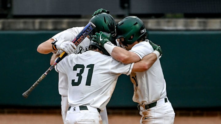 Michigan State's Caleb Berry, center, celebrates his home run with teammates Sam Busch, left, and Nick Williams during the seventh inning in the game against Ohio State on Friday, April 18, 2025, at McLane Stadium in East Lansing.