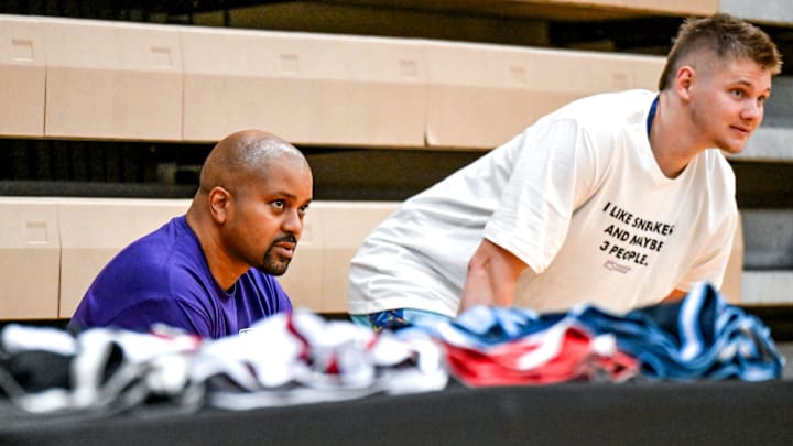 Moneyball Sportswear Founder Desmond Ferguson, left, talks to Michigan State basketball player Jaxon Kohler on Thursday, July 11, 2024, during the Moneyball Pro-Am at Holt High School.
