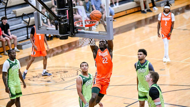 Team Snipes and Michigan State's Trey Fort dunks against Team Faygo during the Moneyball Pro-Am on Thursday, June 26, 2025, at Holt High School.