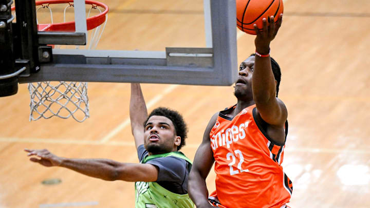 Team Snipes and Michigan State's Trey Fort, right, scores as Team Faygo's Darrius Welch defends during the Moneyball Pro-Am on Thursday, June 26, 2025, at Holt High School.