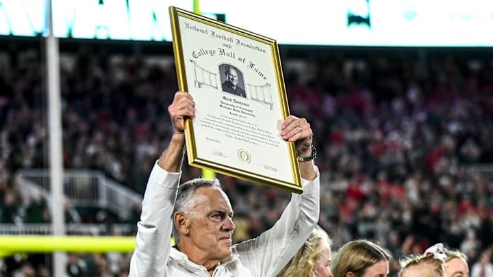 Former Michigan State head coach Mark Dantonio holds up his National Football Foundation Hall of Fame declaration while being recognized and for his addition the the Spartans Ring of Fame during MSU's game against Ohio State on Saturday, Sept. 28, 2024, at Spartan Stadium in East Lansing.
