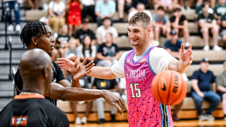 Team Tri-Stars' Michigan State's Carson Cooper, right, smiles as Team Motorcars and MSU's Cam Ward throws in the ball during the Moneyball Pro-Am on Tuesday, July 15, 2025, at Holt High School.