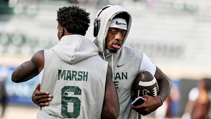 Michigan State's quarterback Aidan Chiles, right, hugs Nick Marsh before the football game against Western Michigan on Friday, Aug. 29, 2025, in East Lansing.