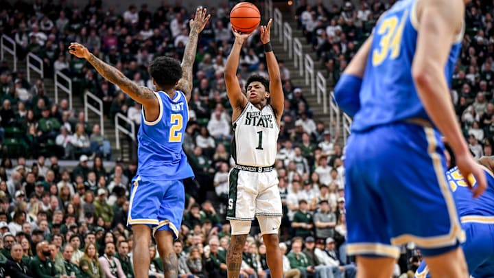 Michigan State's Jeremy Fears Jr., right, makes a 3-pointer against UCLA's Donovan Dent during the first half on Tuesday, Feb. 17, 2026, at the Breslin Center in East Lansing.