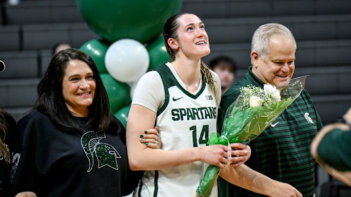 Michigan State's Grace VanSlooten, center, and her parents walk on the court during the senior night ceremony after MSU's win over Northwestern on Wednesday, Feb. 18, 2026, at the Breslin Center in East Lansing. Michigan State's Grace VanSlooten, center, and her parents walk on the court during the senior night ceremony after MSU's win over Northwestern on Wednesday, Feb. 18, 2026, at the Breslin Center in East Lansing.