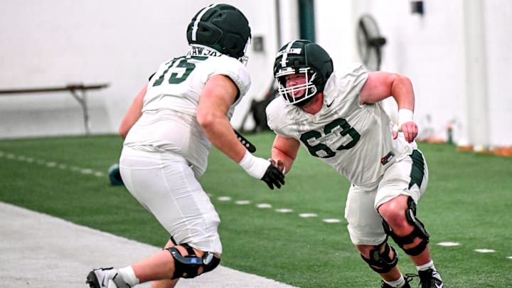 Michigan State's Trent Fraley, right, and Ben Murawski participate in a drill during spring football practice on Tuesday, March 24, 2026, in East Lansing.