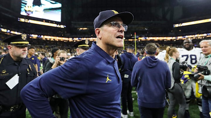 Michigan coach Jim Harbaugh celebrates U-M's 26-0 win over Iowa in the Big Ten championship game in