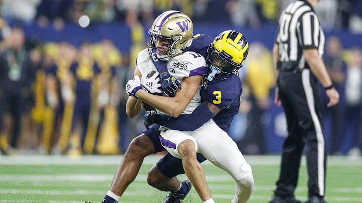 Michigan defensive back Keon Sabb tackles Washington wide receiver Jalen McMillan during the first