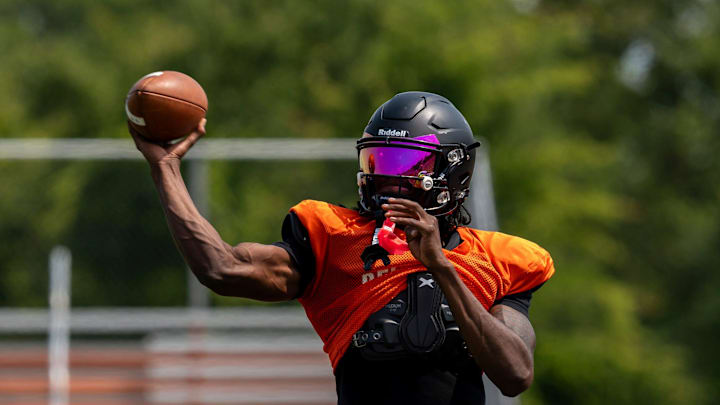 Quarterback Bryce Underwood throws a pass during a team practice at the Belleville High School football field in Belleville on Wednesday, Aug. 14, 2024.