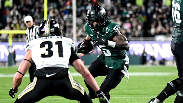Dillon Thieneman squares up on Michigan State running back Nathan Carter in a game in East Lansing last November. He's already emerging as a leader on the 2025 Oregon defense.