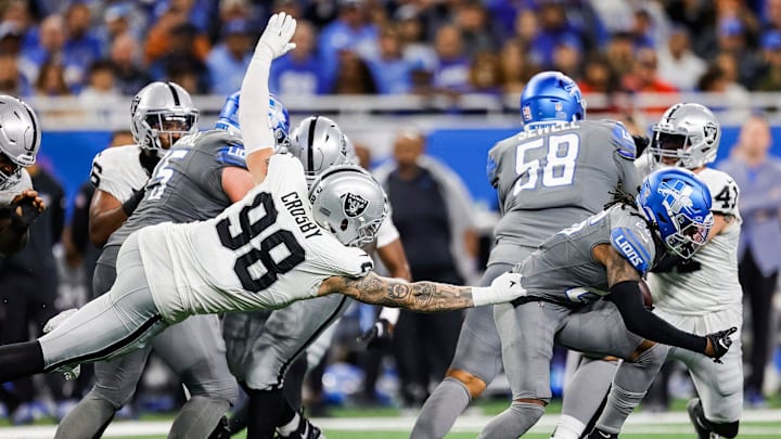 Detroit Lions running back Jahmyr Gibbs (26) is tackled by Las Vegas Raiders defensive end Maxx Crosby (98) during the second half at Ford Field in Detroit on Monday, Oct. 30, 2023.