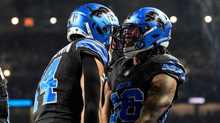 Detroit Lions running back Jahmyr Gibbs (26), right, celebrates a touchdown against Minnesota Vikings with wide receiver Amon-Ra St. Brown (14) during the first half at Ford Field in Detroit on Sunday, Jan. 5, 2025.