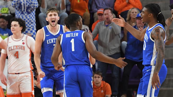 Dec 3, 2024; Clemson, South Carolina, USA; Kentucky forward Andrew Carr (7) and Kentucky forward Brandon Garrison (10) react when Kentucky guard Lamont Butler (1) made a shot near Clemson senior forward Ian Schieffelin (4) during the first half at Littlejohn Coliseum. Mandatory Credit: Ken Ruinard-Imagn Images