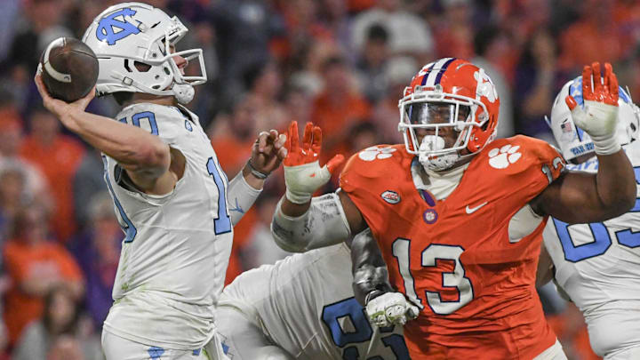 Nov 18, 2023; Clemson, South Carolina, USA; North Carolina Tar Heels quarterback Drake Maye (10) throws against Clemson Tigers defensive tackle Tyler Davis (13) during the third quarter at Memorial Stadium. Mandatory Credit: Ken Ruinard-USA TODAY Sports