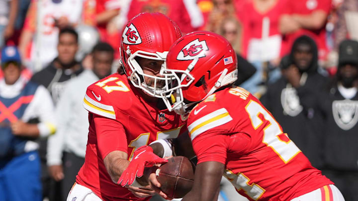 Oct 19, 2025; Kansas City, Missouri, USA; Kansas City Chiefs quarterback Gardner Minshew (17) hands teh ball to running back Brashard Smith (24) against the Las Vegas Raiders during the fourth quarter of the game at GEHA Field at Arrowhead Stadium. Mandatory Credit: Denny Medley-Imagn Images