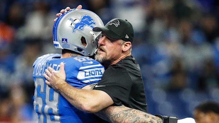 Detroit Lions head coach Dan Campbell hugs offensive tackle Taylor Decker before the Denver Broncos