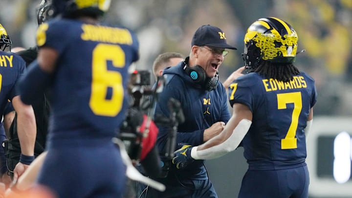 Michigan head coach Jim Harbaugh celebrates a touchdown by Michigan running back Donovan Edwards