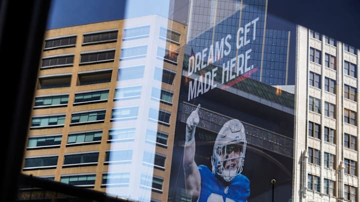 A sign posted on the side of a building hangs as work continues on the setup for the upcoming NFL
