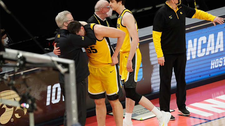Iowa Hawkeyes center Luka Garza (55) hugs Iowa Hawkeyes head coach Fran McCaffery after their 95-80 loss against the Oregon Ducks during the second round of the 2021 NCAA Tournament on Monday, March 22, 2021, at Bankers Life Fieldhouse in Indianapolis, Ind. Mandatory Credit: Barbara Perenic/IndyStar via Imagn Images