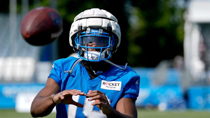Detroit Lions wide receiver Donovan Peoples-Jones catches footballs from the JUGS machine after practice at the Detroit Lions practice facility in Allen Park on Friday, July 26, 2024