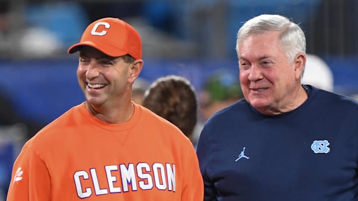 Clemson head coach Dabo Swinney and North Carolina Coach Mack Brown talk before the ACC Championship
