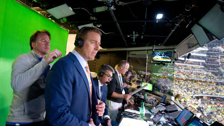 Jan 12, 2015; Arlington, TX, USA; ESPN broadcasters Kirk Herbstreit (center) has his headset adjusted as Chris Fowler (right) looks on at halftime during the broadcast of the College Football Playoff National Championship at AT&T stadium. Mandatory Credit: James Lang-USA TODAY Sports