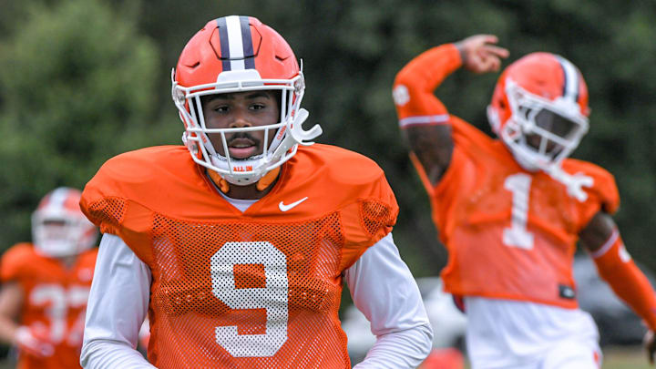 Clemson safety R.J. Mickens (9) and safety Andrew Mukuba (1) warm up during preseason practice.