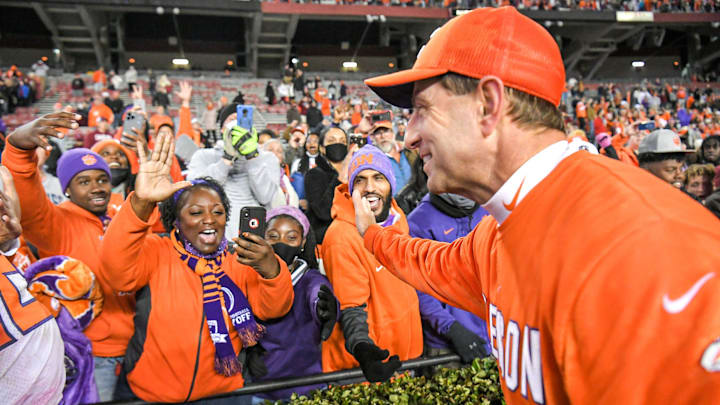 Clemson head coach Dabo Swinney celebrates with fans after the victory over the Gamecocks