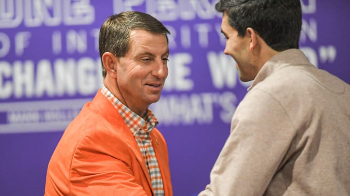 Clemson Head Football Coach Dabo Swinney shakes hands with Director of Athletics Graham Neff talks during a press conference in Clemson, S.C. Wednesday, February 2, 2022. 