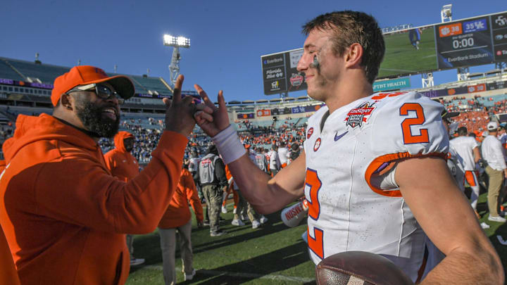 Clemson quarterback Cade Klubnik (2), right, celebrates with Tajh Boyd after the TaxSlayer Gator Bowl at EverBank Stadium in Jacksonville, Florida, Friday, December 29, 2023. Clemson won 38-35.