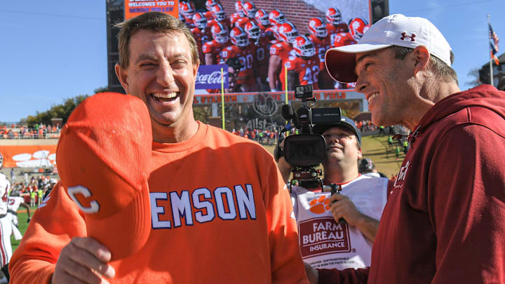 Nov 26, 2022; Clemson, SC, USA; Clemson head coach Dabo Swinney, left, and South Carolina head coach Shane Beamer talk before the game at Memorial Stadium in Clemson, S.C. Saturday, Nov. 26, 2022. Mandatory Credit: Ken Ruinard-Imagn Images