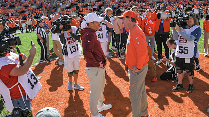 Nov 26, 2022; Clemson, SC, USA; Clemson head coach Dabo Swinney, right, and South Carolina head coach Shane Beamer talk before the game at Memorial Stadium in Clemson, S.C. Saturday, Nov. 26, 2022.    Mandatory Credit: Ken Ruinard-Imagn Images