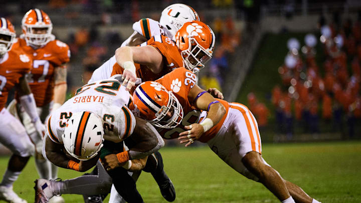 Oct 10, 2020; Clemson, South Carolina, USA; Miami Hurricanes running back Cam'Ron Harris (23) is tackled by Clemson Tigers safety Elijah Turner (38) during the fourth quarter at Memorial Stadium. Mandatory Credit: Ken Ruinard-Imagn Images Oct 10, 2020; Clemson, South Carolina, USA; Miami Hurricanes running back Cam'Ron Harris (23) is tackled by Clemson Tigers safety Elijah Turner (38) during the fourth quarter at Memorial Stadium. Mandatory Credit: Ken Ruinard-Imagn Images