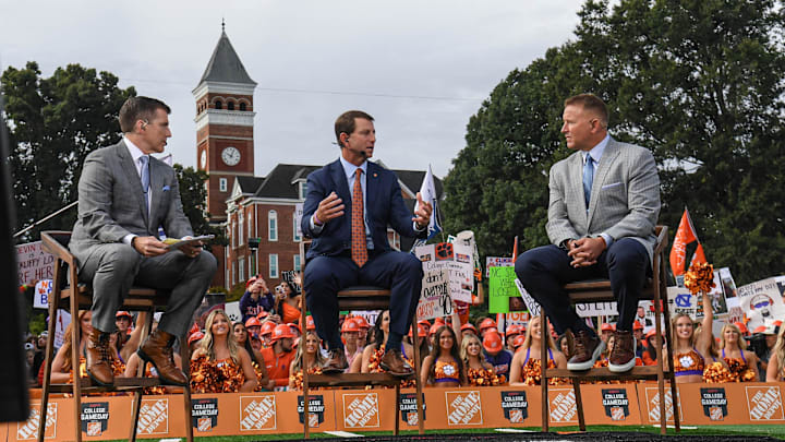 Oct 1, 2022; Clemson, South Carolina, USA; Clemson head coach Dabo Swinney (middle) is interviewed while seated between analysts Rece Davis and Kirk Herbstreit during ESPN College GameDay before playing the NC State Wolfpack at Memorial Stadium. Mandatory Credit: Ken Ruinard-Imagn Images