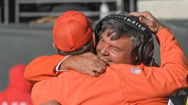 Clemson offensive line coach Matt Luke, right, hugs Head Coach Dabo Swinney during the fourth quarter of the TaxSlayer Gator Bowl at EverBank Stadium in Jacksonville , Florida, Friday, December 29, 2023. Clemson won 38-35.