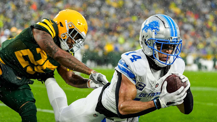 Detroit Lions wide receiver Amon-Ra St. Brown (14) makes a catch for a touchdown against Green Bay Packers cornerback Keisean Nixon (25) during the first half at Lambeau Field in Green Bay, Wis. on Sunday, Nov. 3, 2024.
