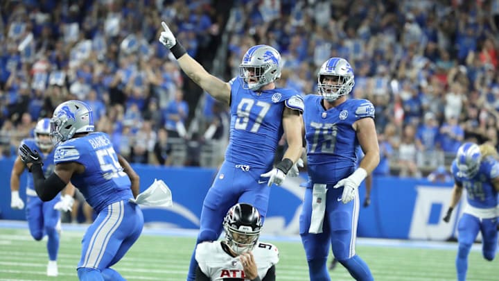 Detroit Lions defensive end Aidan Hutchinson (97) celebrates after linebacker Derrick Barnes (55)