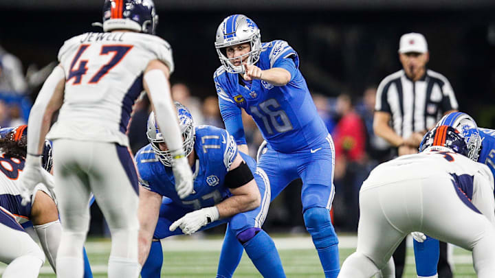 Detroit Lions quarterback Jared Goff (16) talks to center Frank Ragnow (77) before a snap against