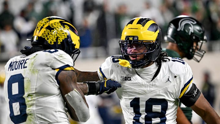 Michigan's Derrick Moore, left, celebrates a sack with Troy Bowles during the fourth quarter in the game against Michigan State on Saturday, Oct. 25, 2025, at Spartan Stadium in East Lansing.