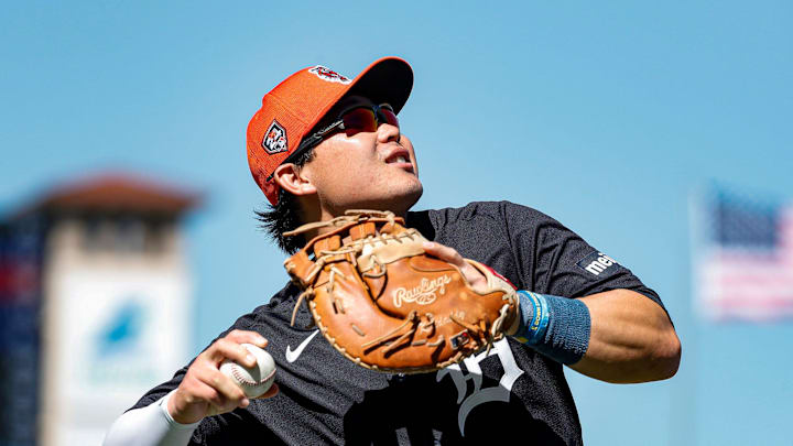 Tigers first baseman Keston Hiura throws a foul ball to fans during the third inning against the