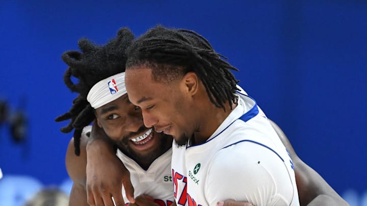 Detroit Pistons forward Isaiah Stewart (28) and Detroit Pistons forward Ronald Holland II (5) hug and laugh as they walk off the court during a timeout against the Philadelphia 76ers in the second half at Little Caesars Arena on Mar 12, 2026.