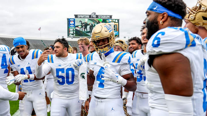 UCLA's Ezavier Staples, center, holds up a Michigan State towel while celebrating with the team after the Bruins win over Michigan State on Saturday, Oct. 11, 2025, at Spartan Stadium in East Lansing. UCLA's Ezavier Staples, center, holds up a Michigan State towel while celebrating with the team after the Bruins win over Michigan State on Saturday, Oct. 11, 2025, at Spartan Stadium in East Lansing.
