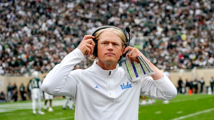 UCLA's assistant head coach Jerry Neuheisel adjusts his headset during the third quarter in the game against Michigan State on Saturday, Oct. 11, 2025, at Spartan Stadium in East Lansing.